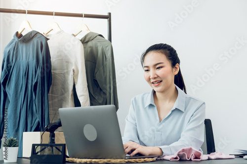 Young asian entrepreneurs chatting with customers at the computer while smiling. photo