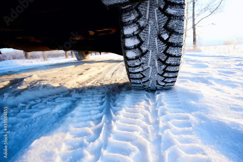 winter tires with spikes on the snow / transport road northern wheels, climate winter season © kichigin19
