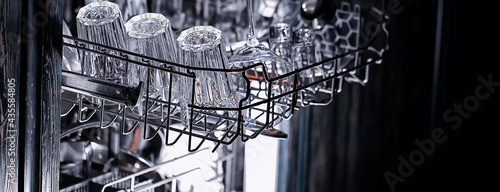 Bild auf Leinwand dishes in an open dishwasher, home style lifestyle, cleanliness and convenience