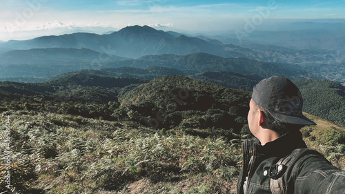 young man Thai boy Asian hipster men backpacker enjoying on beautiful landscape scenery view jungle mountains forest at Kew Mae Pan Nature Trail Doi Inthanon National Park, Chiang Mai, Thailand.