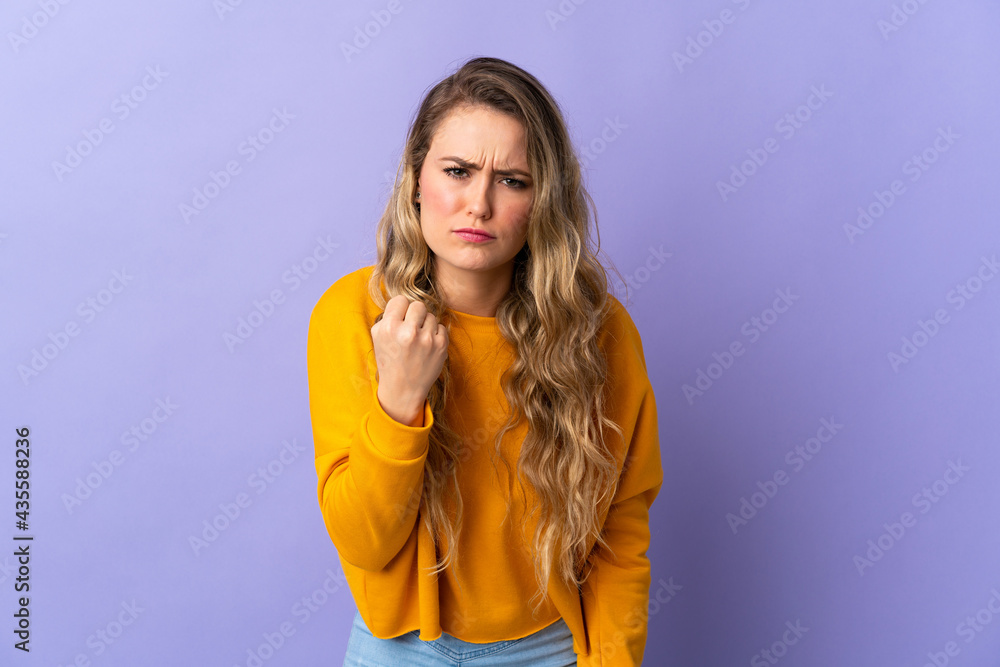 Fototapeta premium Young Brazilian woman isolated on purple background with unhappy expression