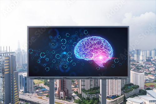 Brain hologram on billboard with Kuala Lumpur cityscape background at day time. Street advertising poster. Front view. KL is the largest science hub in Malaysia, Asia. Coding and high-tech science.