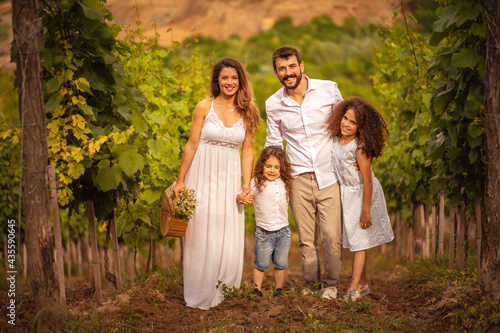 Portrait of young family in vineyard.