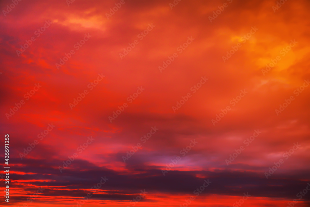 Sky sunset in the evening with colorful orange sunlight. Beautiful majestic nature background