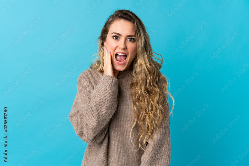 Young Brazilian woman isolated on blue background with surprise and shocked facial expression Young Brazilian woman isolated on blue background with surprise and shocked facial expression