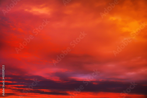 Sky sunset in the evening with colorful orange sunlight. Beautiful majestic nature background © es0lex