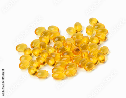scattered oval tablets with fish oil, omega 3 on a white background