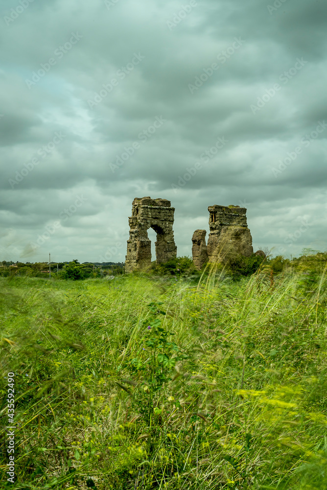 The Parco degli Acquedotti during a cloudy day with dramatic sky, a public archaeological park in Rome, part of the Via Appia Regional Park, with monumental remains of Roman aqueducts