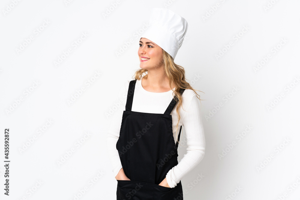 Young Brazilian chef woman isolated on white background looking side Young Brazilian chef woman isolated on white background looking side
