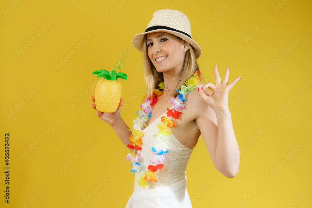 Young smiling woman in swimsuit showing pineapple isolated over yellow background. Young smiling woman in swimsuit showing pineapple isolated over yellow background.