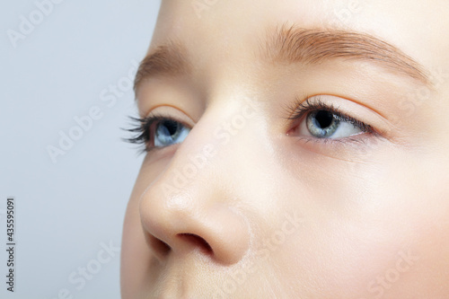 Fototapeta Naklejka Na Ścianę i Meble -  Closeup shot of human teenager girl face. Young female with natural face and eyes beauty makeup