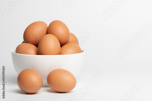 Brown eggs in the white blow. white background.
