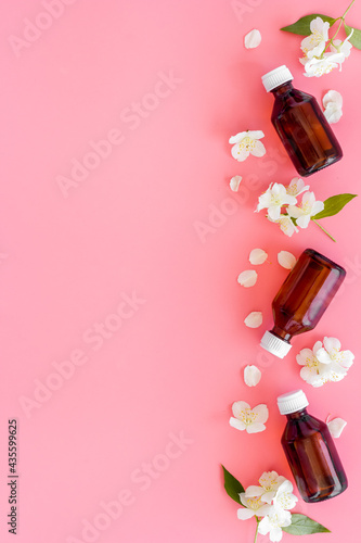 Jasmine flowers with essence oil bottle. Top view