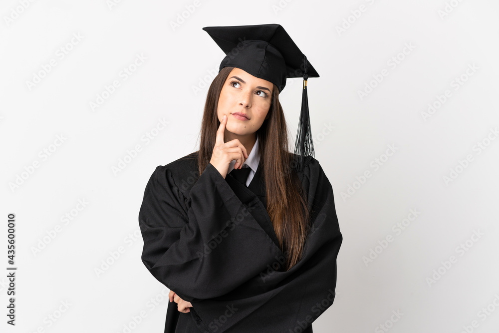 Teenager Brazilian university graduate over isolated white background having doubts while looking up Teenager Brazilian university graduate over isolated white background having doubts while looking up