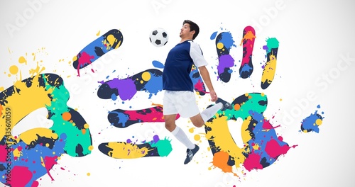 Composition of football player with ball over colourful handprints and white background photo