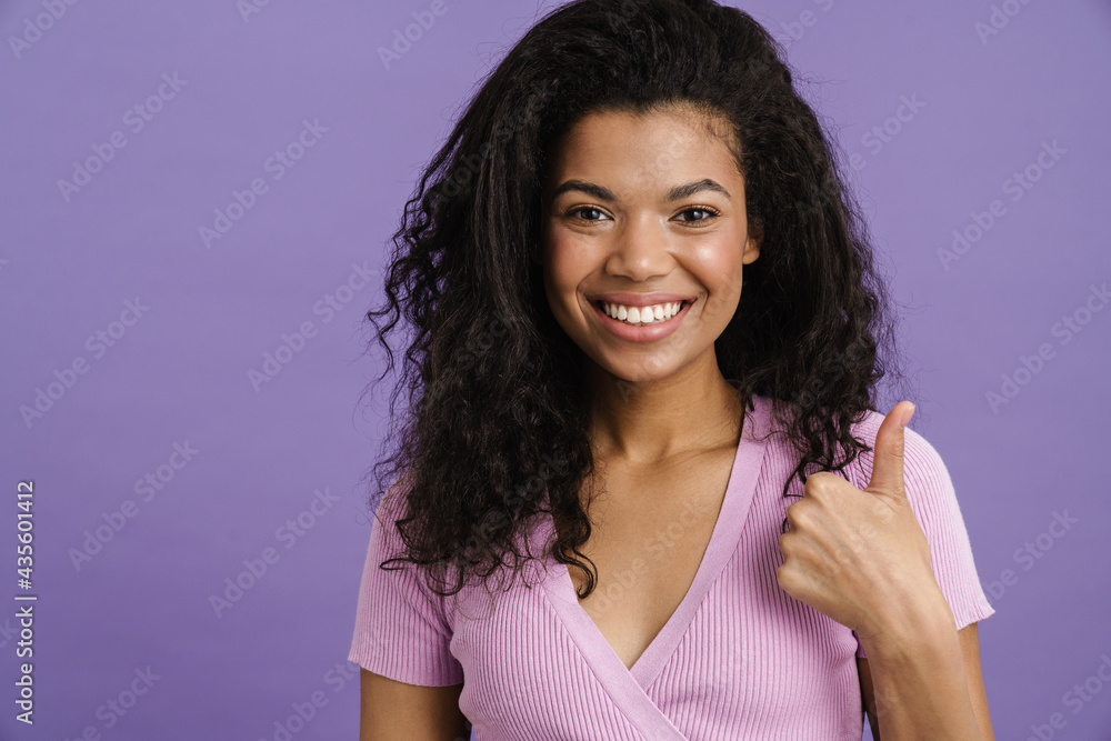 Young black woman laughing while gesturing thumb up Young black woman laughing while gesturing thumb up
