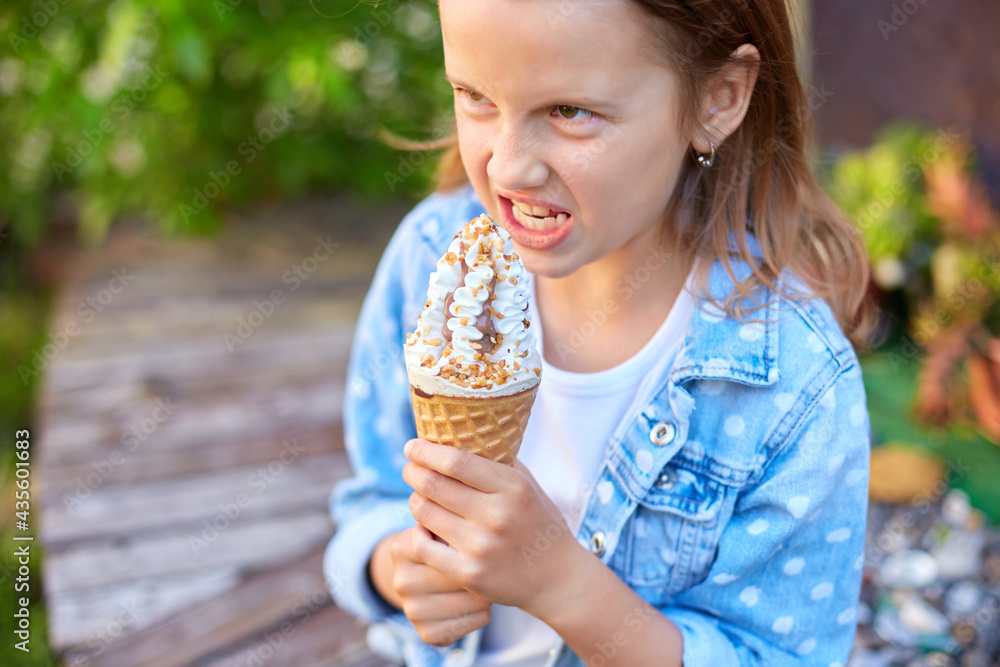 Cute girl with italian ice cream cone smiling while resting in park on summer day, child enjoying ice cream outdoor, happy holidays, summertime Cute girl with italian ice cream cone smiling while resting in park on summer day, child enjoying ice cream outdoor, happy holidays, summertime