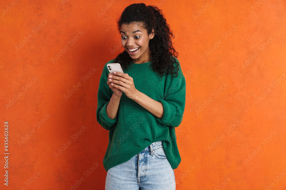 Fototapeta premium Happy young african woman in casual wear standing