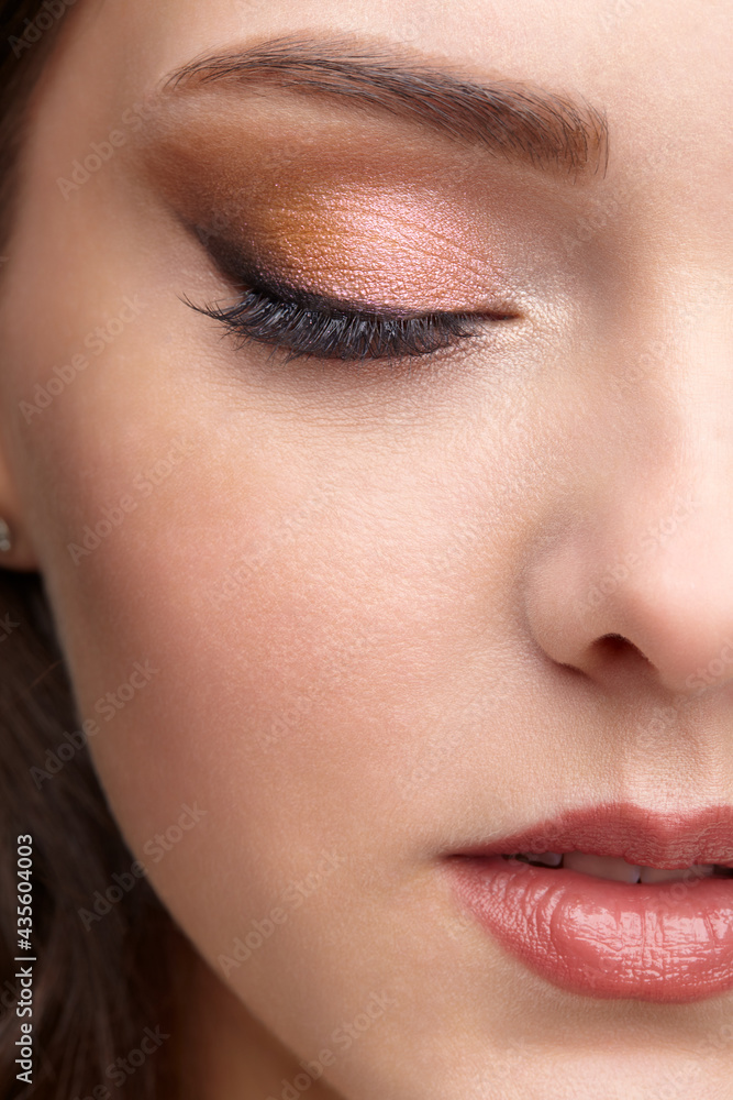 Fototapeta premium Closeup portrait of female face with red lips and smoky eyes beauty makeup.