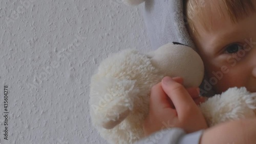 Little boy hugs a stuffed toy