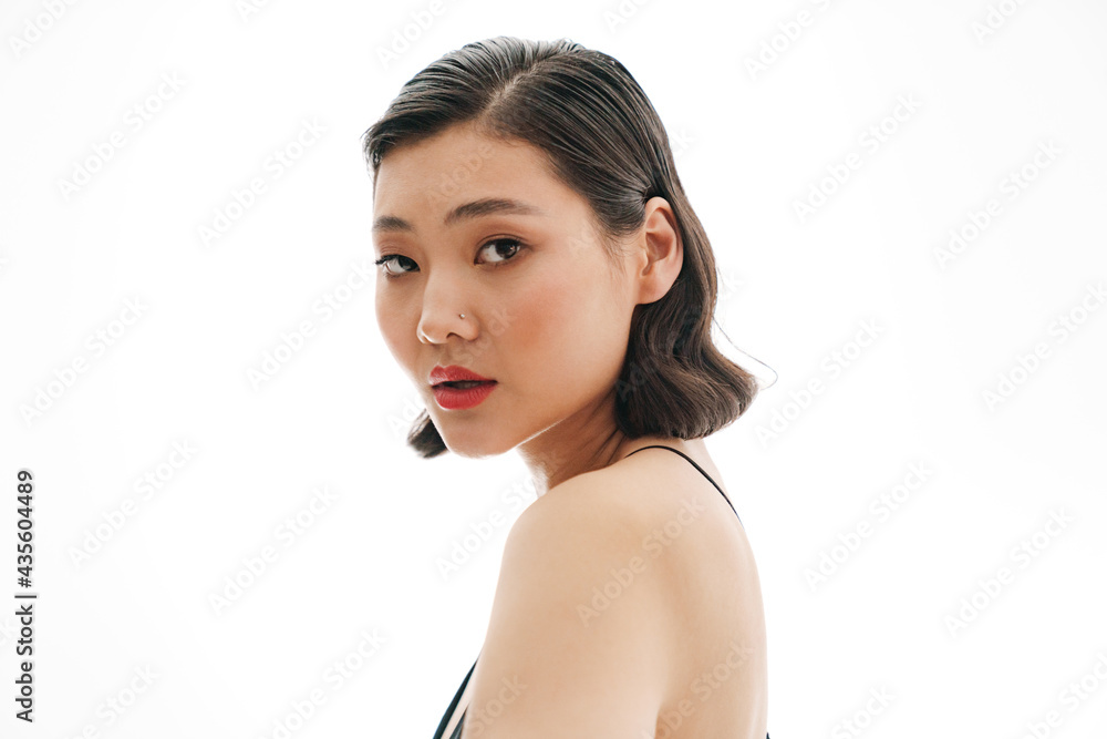 Brunette asian woman wearing swimsuit posing on camera Brunette asian woman wearing swimsuit posing on camera
