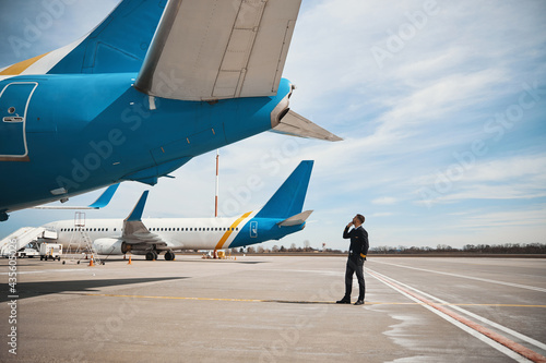 Pilot checking rear part of plane before flight photo