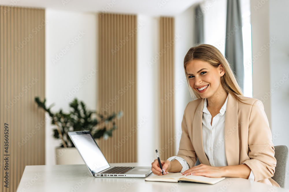 Portrait of woman, posing for camera, writing something. Portrait of woman, posing for camera, writing something.