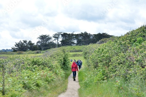 group of senior hikers on the path at Landrellec in Brittany. France