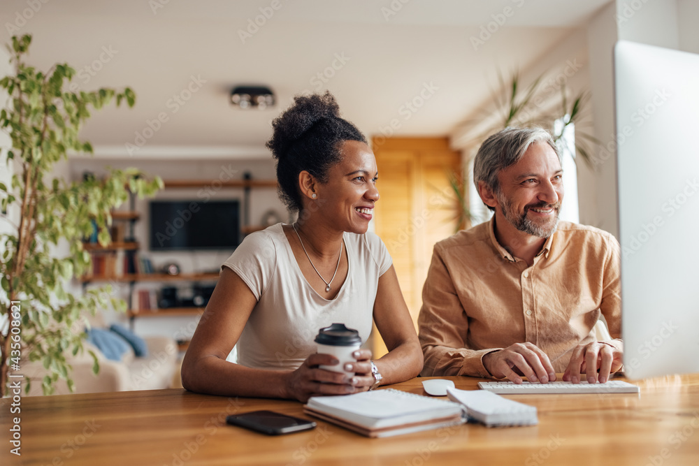 Adult man, showing something to his wife online. Adult man, showing something to his wife online.