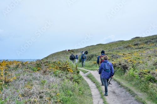 group of senior hikers on the path at Landrellec in Brittany. France