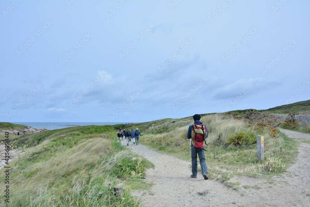 group of senior hikers on the path at Landrellec in Brittany. France