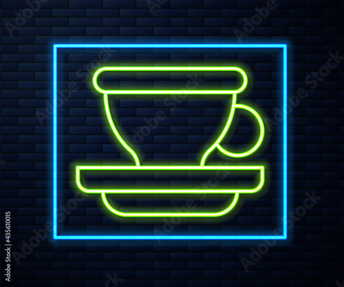 Glowing neon line Coffee cup icon isolated on brick wall background. Tea cup. Hot drink coffee. Vector