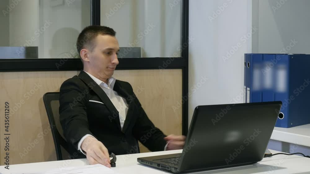 Young Businessman At Work. A Successful Manager Working With Papers In Office Young Businessman At Work. A Successful Manager Working With Papers In Office