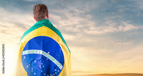 Brazilian man with Brazilian flag looking at the horizon photo