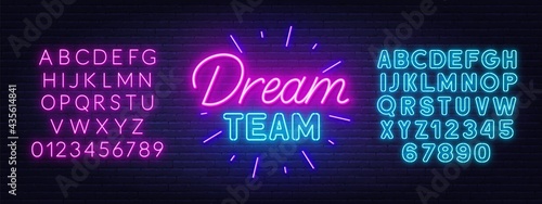 Dream Team neon sign on brick wall background.