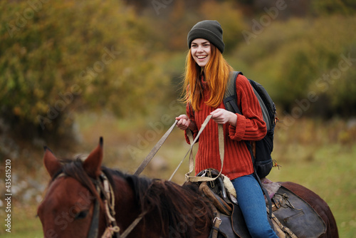 cheerful woman hiker ride a horse fun travel mountains