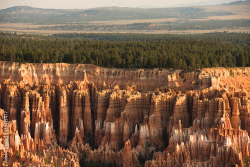 Layers of hoodoos, pine trees, and mountains at Bryce Canyon National Park Utah.