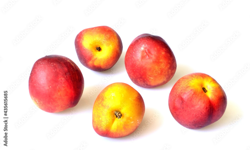 five nectarines lie on a white background five nectarines lie on a white background