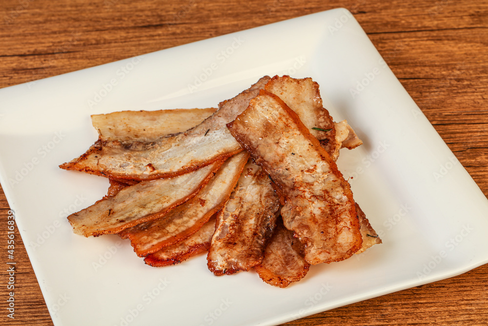 Roasted juicy bacon in the plate Roasted juicy bacon in the plate
