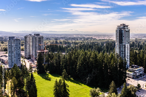 An elevated view of the tall trees and rising sky-rises of Coquitlam, British Colombia