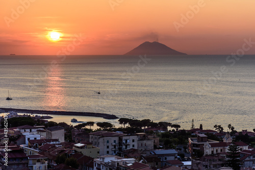 A view of Stromboli during sunset as seen from the height of the coastal mountains of Vibo Valentia, Calabria, Italy