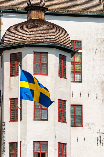 Old castle with the Swedish flag at a tower