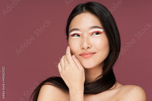 happy woman with bare shoulders on pink background cropped view clear skin