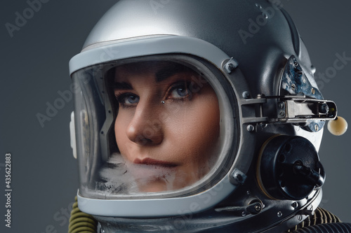 Headshot of modern spacewoman dressed in spacesuit