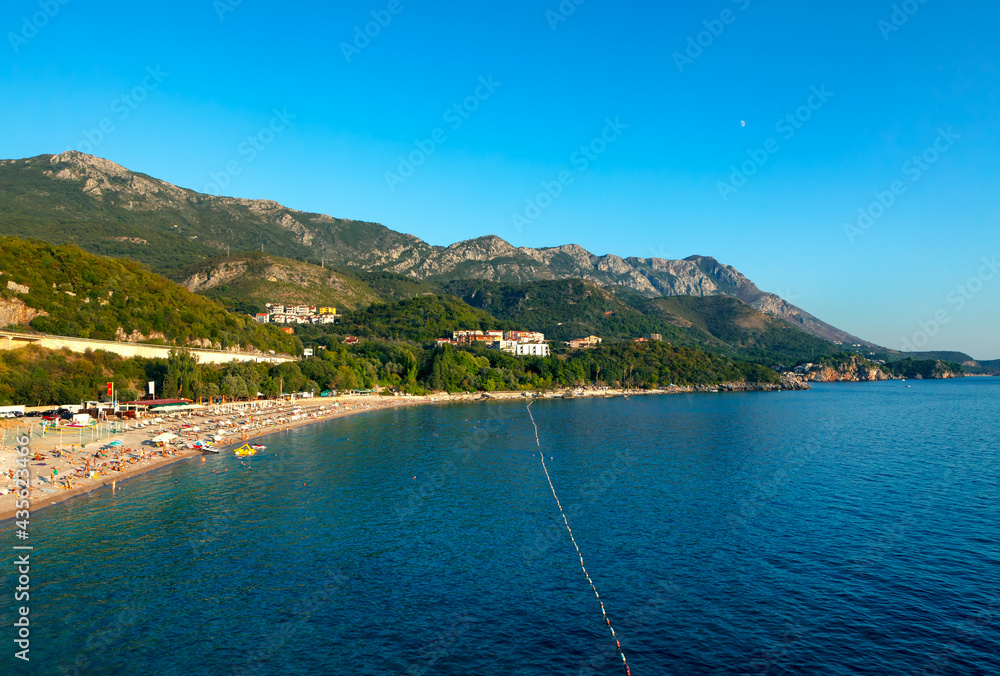 Kamenovo beach in Rafailovici Montenegro . Pebbly place with restaurants and views . Panorama of Adriatic coast