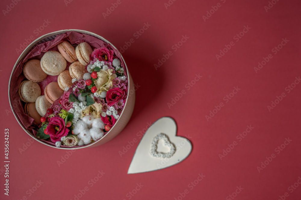Mothers day, valentine day, women day, spring holidays seasonal sale, shopping, love, special offer, discount. Gift with flowers and macaroons on red background. Mothers day, valentine day, women day, spring holidays seasonal sale, shopping, love, special offer, discount. Gift with flowers and macaroons on red background.
