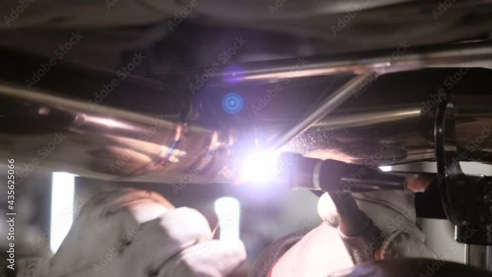 Welding Process. Worker Doing Welding Job. A Man Doing Argon Welding Parts. Welder Welding A Metal Parts On Vehicle Welding Process. Worker Doing Welding Job. A Man Doing Argon Welding Parts. Welder Welding A Metal Parts On Vehicle