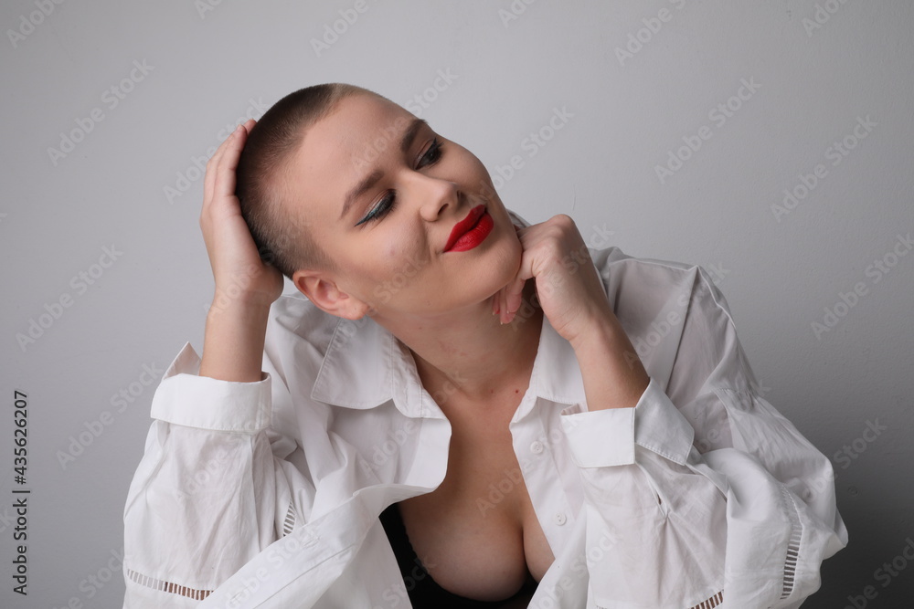 Happy young bald woman, posing in the studio. Isolated. Happy young bald woman, posing in the studio. Isolated.