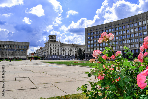 Sumy, Ukraine - June 22, 2020: Cityscape on Independence Square in Sumy. City skyline with blooming roses against the background of soviet and older architecture
