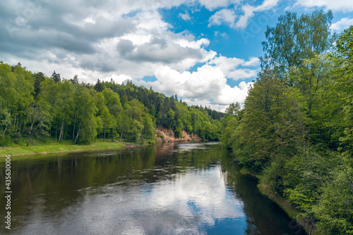 Landscape view of red sandstone caves on Gauja river in Sigulda  Latvia on a cloudy spring day